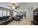 Comfortable living room with leather furniture, open to the kitchen, and lots of natural light from shuttered windows at 6614 E Portia St, Mesa, AZ 85215
