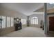 Bright living room features plantation shutters, neutral paint and carpet at 6614 E Portia St, Mesa, AZ 85215