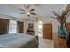 Comfortable primary bedroom featuring a ceiling fan, natural lighting, and a decorative furniture set at 6614 E Portia St, Mesa, AZ 85215