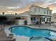 Backyard pool area with a spa, outdoor seating, and string lights for a relaxing atmosphere at 6614 E Portia St, Mesa, AZ 85215