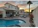 Backyard pool features a spa, lounge chairs, covered patio, and landscaped yard at 6614 E Portia St, Mesa, AZ 85215