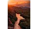 Sunset view with a river winding through rugged terrain, offers peace, and beauty at 6614 E Portia St, Mesa, AZ 85215