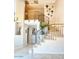 Elegant staircase featuring wrought iron railing and neutral tile flooring leading to the upper level with decorative wall art at 6614 E Portia St, Mesa, AZ 85215