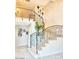 Carpeted staircase with decorative wrought iron banister and railing leading to second story overlooking entryway at 6614 E Portia St, Mesa, AZ 85215