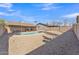 Spacious backyard with a refreshing pool, desert landscaping, and covered patio seating area at 6913 E Kings Ave, Scottsdale, AZ 85254