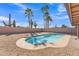 Private backyard features a charming kidney-shaped pool, desert landscaping, and block wall at 6913 E Kings Ave, Scottsdale, AZ 85254