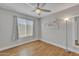 Bright bedroom offering wood floors, a neutral color palette, large window and ceiling fan at 6913 E Kings Ave, Scottsdale, AZ 85254