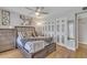 Comfortable bedroom featuring wood floors, contemporary art, ceiling fan and closet with decorated sliding doors at 6913 E Kings Ave, Scottsdale, AZ 85254