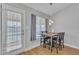 Bright dining area with wood flooring, a view of the outdoor pool, and modern pendant lighting at 6913 E Kings Ave, Scottsdale, AZ 85254