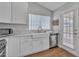 Charming kitchen featuring white cabinets, stainless steel appliances, and a bright window over the sink at 6913 E Kings Ave, Scottsdale, AZ 85254