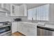 Bright kitchen features white cabinets, stainless steel appliances, and a farmhouse sink at 6913 E Kings Ave, Scottsdale, AZ 85254