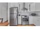 Updated kitchen featuring stainless steel appliances, white cabinets and wood flooring at 6913 E Kings Ave, Scottsdale, AZ 85254