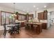 Modern kitchen with dark wood cabinets, granite countertops, stainless steel appliances, and a breakfast bar at 7047 W Saint John Rd, Glendale, AZ 85308