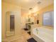 Bathroom featuring tile floors, neutral walls, and a bathtub at 7452 W Los Gatos Dr, Glendale, AZ 85310