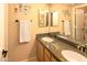 Bathroom featuring a double sink vanity with granite countertop and decor at 7452 W Los Gatos Dr, Glendale, AZ 85310