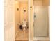 Bathroom featuring tiled floors, toilet, and glass-door shower at 7452 W Los Gatos Dr, Glendale, AZ 85310