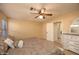 Bedroom with fan, cream walls and decorative headboard at 7452 W Los Gatos Dr, Glendale, AZ 85310