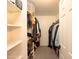 Walk-in closet with hanging racks, shelves, and ample storage space at 7452 W Los Gatos Dr, Glendale, AZ 85310