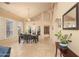 Open-concept dining room with a large window for natural light, a modern chandelier, and neutral paint colors at 7452 W Los Gatos Dr, Glendale, AZ 85310