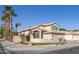 Exterior side view of a charming home with a well-kept lawn, desert landscaping, and a two-car garage at 7452 W Los Gatos Dr, Glendale, AZ 85310