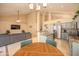 Open-concept kitchen with granite counters, stainless appliances, and an adjacent living area with a cozy gray sofa at 7452 W Los Gatos Dr, Glendale, AZ 85310