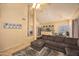 Spacious living area featuring an open layout to the kitchen, a comfortable sofa, and neutral paint colors at 7452 W Los Gatos Dr, Glendale, AZ 85310