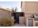 Outdoor kitchen with a built in grill, sink, and small refrigerator at 7452 W Los Gatos Dr, Glendale, AZ 85310