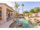 Backyard pool and patio with desert landscaping and covered porch at 7452 W Los Gatos Dr, Glendale, AZ 85310