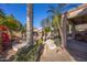 Stunning backyard pool area with lush greenery, rocks, and palm trees for ultimate relaxation at 7452 W Los Gatos Dr, Glendale, AZ 85310