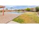 Spacious backyard featuring a refreshing swimming pool, a spa, and mature desert landscaping at 7953 W Topeka Dr, Glendale, AZ 85308