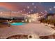 Beautiful backyard with a pool, spa, and patio enhanced by string lights, creating a relaxing outdoor oasis at 7953 W Topeka Dr, Glendale, AZ 85308