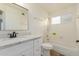 Bright bathroom with modern vanity, tub-shower combo, and neutral color scheme at 7953 W Topeka Dr, Glendale, AZ 85308