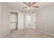 Bright bedroom with a fan, closet, neutral walls, and carpeted floor at 7953 W Topeka Dr, Glendale, AZ 85308