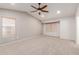 Spacious bedroom with vaulted ceilings, neutral carpet, and abundant natural light from two windows at 7953 W Topeka Dr, Glendale, AZ 85308