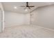 Spacious bedroom with neutral carpet, one window and ceiling fan, offering plenty of room to relax at 7953 W Topeka Dr, Glendale, AZ 85308