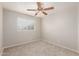 Bedroom with a window, fan, neutral walls and carpeted floor at 7953 W Topeka Dr, Glendale, AZ 85308