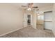 Bedroom with a carpeted floor, a fan, access to the hall, and closet with sliding mirror doors at 7953 W Topeka Dr, Glendale, AZ 85308
