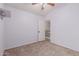 Bedroom with fan, carpeted floor, access to the hall, and closet with doors at 7953 W Topeka Dr, Glendale, AZ 85308