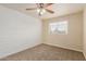 Bedroom with carpeted floor, a fan, shiplap accent wall and window at 7953 W Topeka Dr, Glendale, AZ 85308