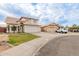 Charming two-story home featuring desert landscaping, a neutral color palette, and a two-car garage at 7953 W Topeka Dr, Glendale, AZ 85308