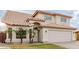 Charming home featuring desert landscaping, a neutral color palette, and a two-car garage at 7953 W Topeka Dr, Glendale, AZ 85308