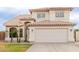 Two-story home featuring a tile roof, arched entryway, stucco siding, and a two-car garage at 7953 W Topeka Dr, Glendale, AZ 85308