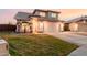 Two-story home featuring a tile roof, arched entryway, well-manicured lawn, and a two-car garage at 7953 W Topeka Dr, Glendale, AZ 85308