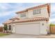 Two-story home featuring a tile roof, arched entryway, stucco siding, and a two-car garage at 7953 W Topeka Dr, Glendale, AZ 85308