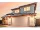 Two-story home featuring a tile roof, arched entryway, stucco siding, and a two-car garage at 7953 W Topeka Dr, Glendale, AZ 85308