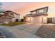 View of a two-story house with a tile roof, two-car garage, driveway, and landscaping at 7953 W Topeka Dr, Glendale, AZ 85308