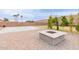 Relaxing fire pit area with pavers and mature trees in a serene backyard setting at 7953 W Topeka Dr, Glendale, AZ 85308