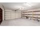 Spacious two-car garage with ample shelving and storage space for tools and equipment at 7953 W Topeka Dr, Glendale, AZ 85308