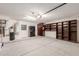Well-organized garage featuring built-in shelving, water heater, and ample storage cabinets at 7953 W Topeka Dr, Glendale, AZ 85308