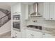 Close up of modern kitchen with white cabinets, subway tile backsplash, and stainless steel appliances at 7953 W Topeka Dr, Glendale, AZ 85308